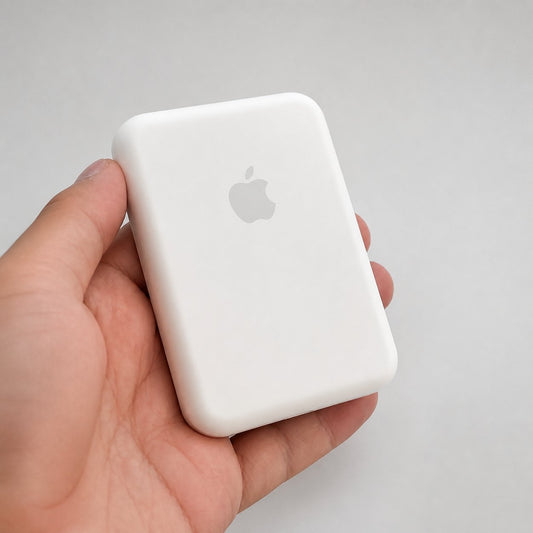 White magnetic power bank held in a hand