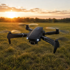 Drone hovering over a field at sunset
