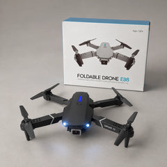 Unfolded drone with its retail box on grey
