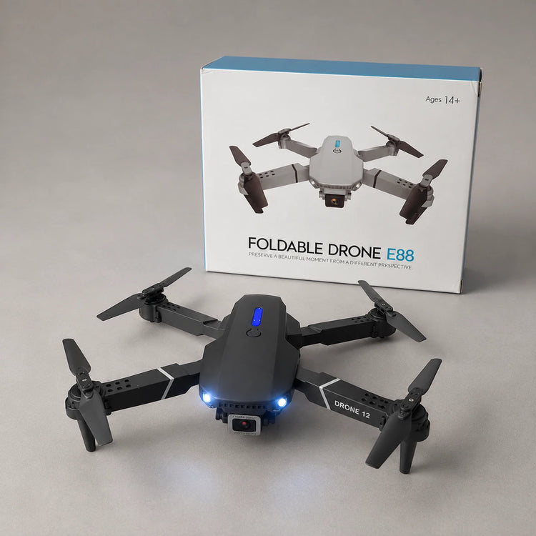 Unfolded drone with its retail box on grey