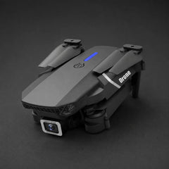 Folded black drone on charcoal