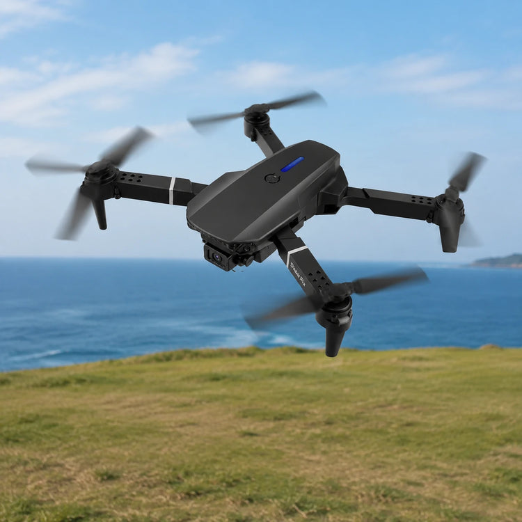 Black drone flying near the coast