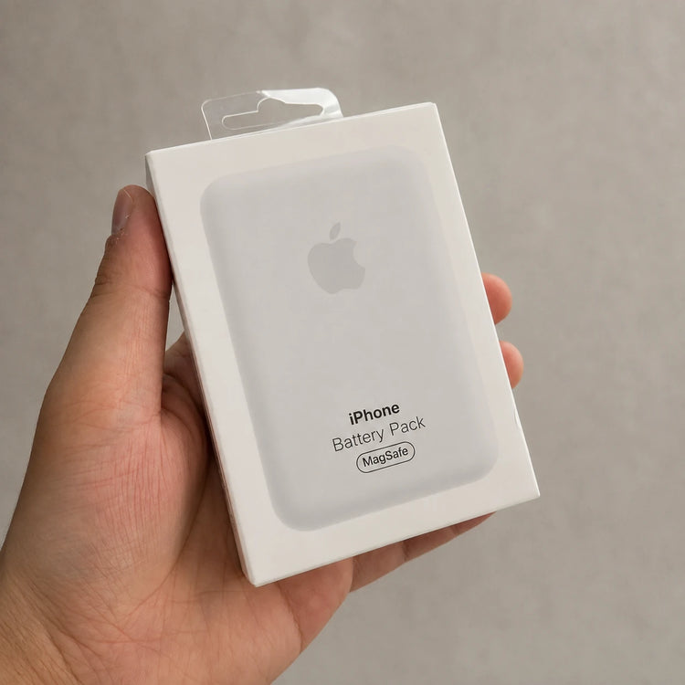 Hand holding a magnetic wireless power bank retail box labeled iPhone Battery Pack MagSafe